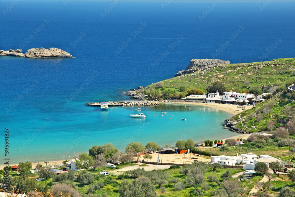 Panoramic view of Lindos sand beach and fishing port. Rhodes island, Greece.