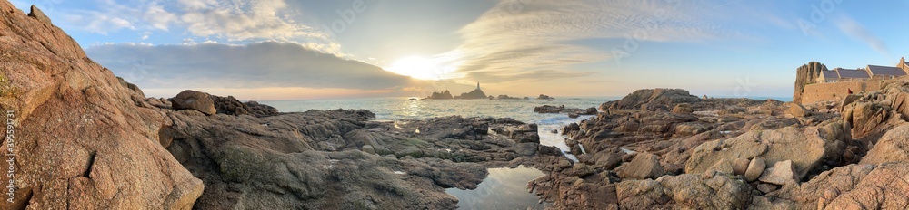 Obraz premium La Corbiere lighthouse, Jersey, U.K. Very mild November afternoon at a coastal landmark at high tide.