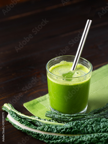 Glass of fresh organic green juice with a stainless steel drinking straw; copy space  photo