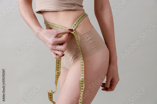 Studio beauty portrait of a young, healthy, beautiful, fresh skinned caucasian woman on a grey background