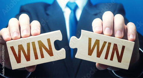 Photography Man holding two puzzles with Win-Win words
