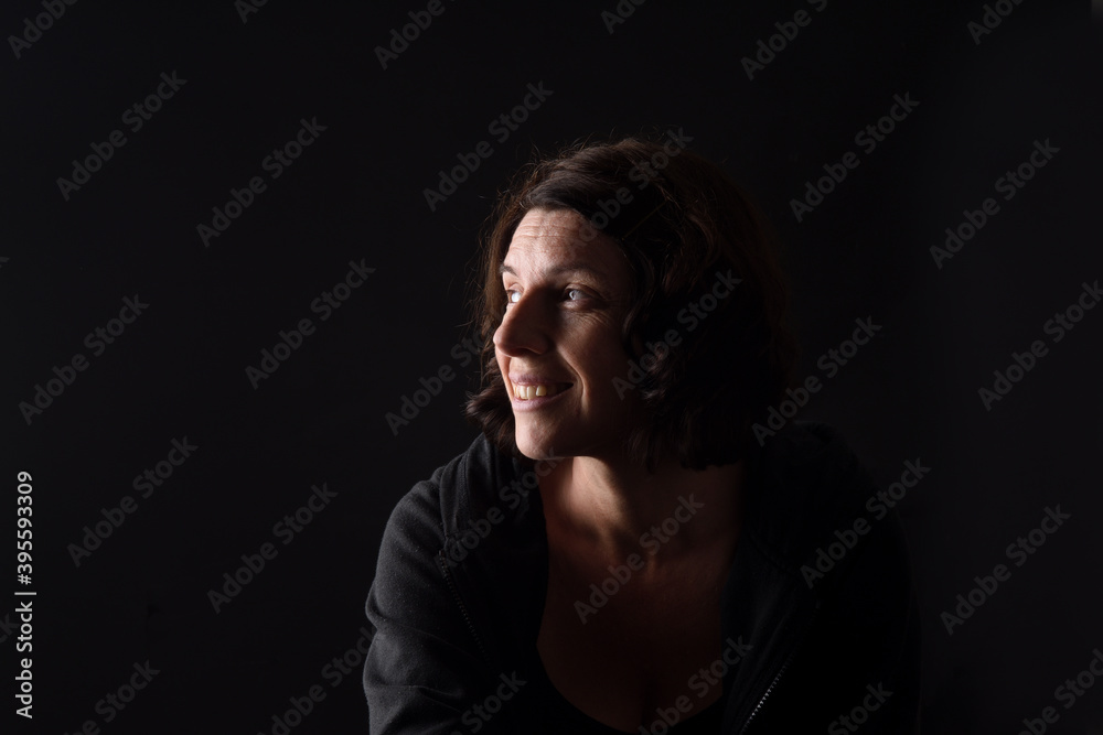 portrait of a woman smiling on black background portrait of a woman smiling on black background