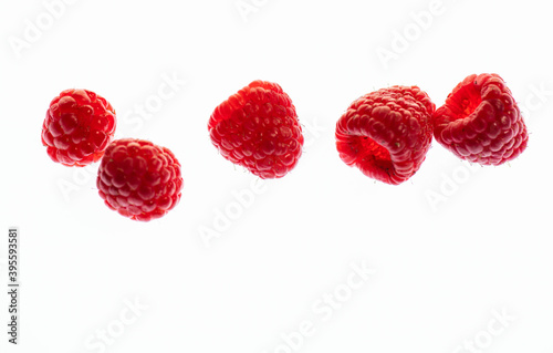 Five raspberry illuminated from behind