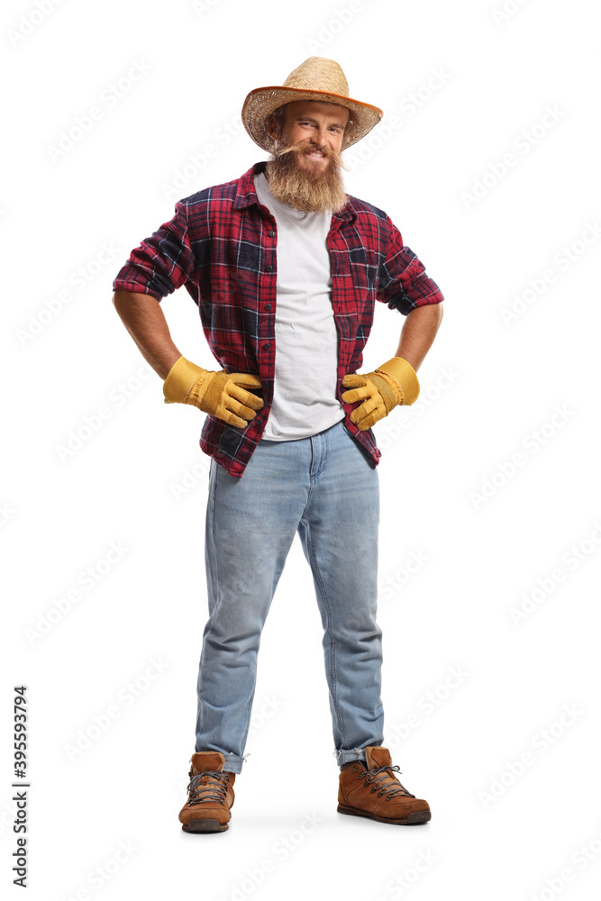 Full length portrait of a bearded farmer with gloves and a straw hat Full length portrait of a bearded farmer with gloves and a straw hat