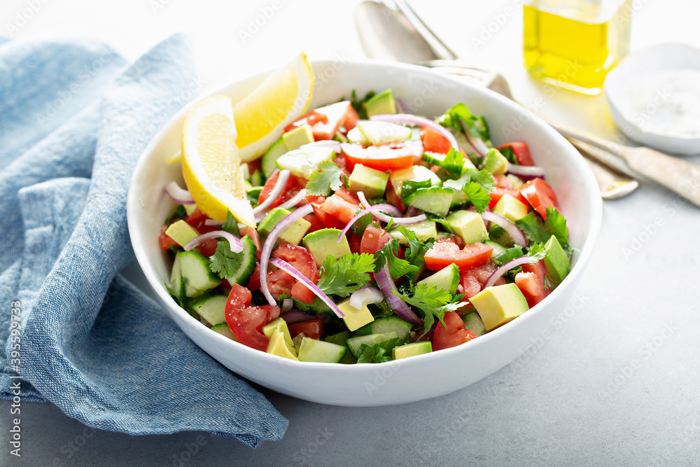 Fresh vegetables chopped salad with tomato, cucumber and avocado Fresh vegetables chopped salad with tomato, cucumber and avocado