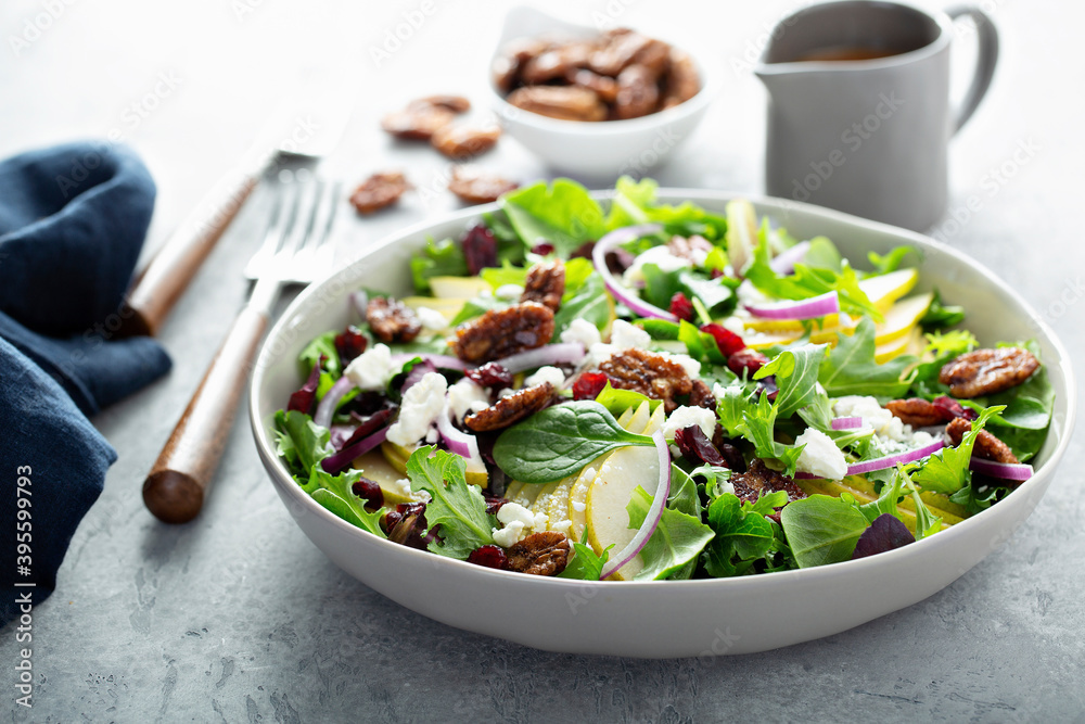 Fall salad with pears, mixed greens and caramelized pecan Fall salad with pears, mixed greens and caramelized pecan
