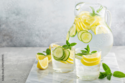 Refreshing lemonade with cucumber in a pitcher photo