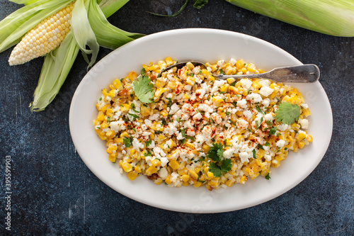 Mexican street corn, elote with cotija cheese, fresh cilantro and chili photo