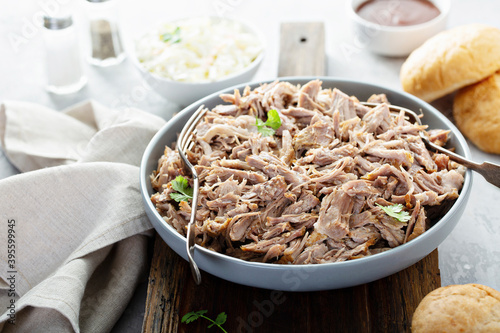 Pulled pork on a platter with cole slaw and bbq sauce