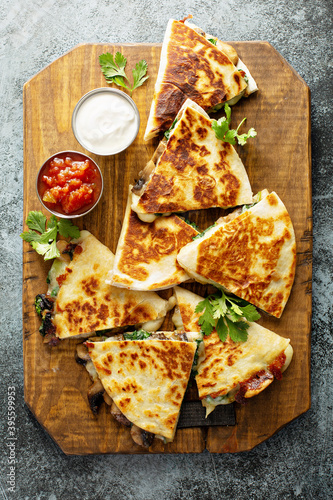 Mushroom, spinach and cheese quesadillas with sour cream and salsa photo