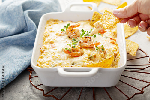 Spicy cheese and shrimp dip with tortilla chips photo