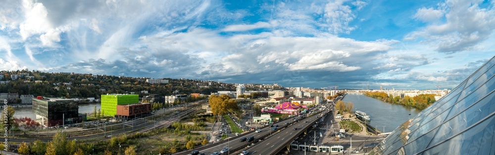 Topview of the southern entrance to Lyon, the railway line, the A7 motorway and the modern Confluences district. The winter fun fair is already showing its joyful colors.
