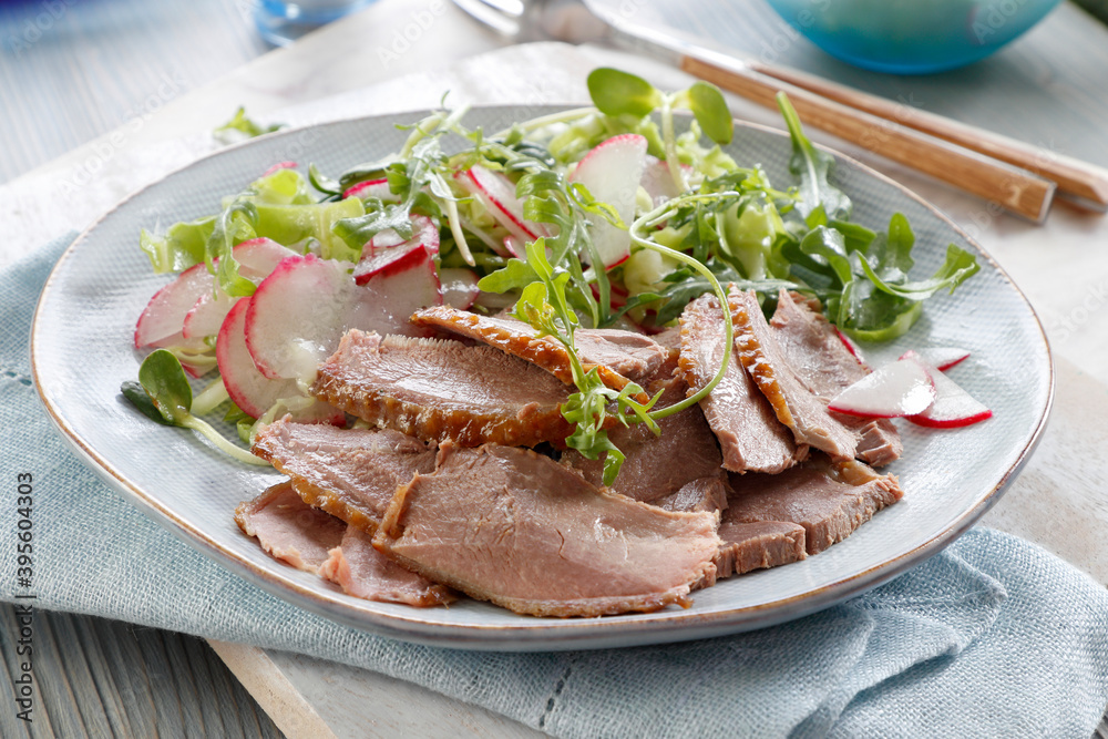 Thinly cut goose breast with radish and rocket salad Thinly cut goose breast with radish and rocket salad