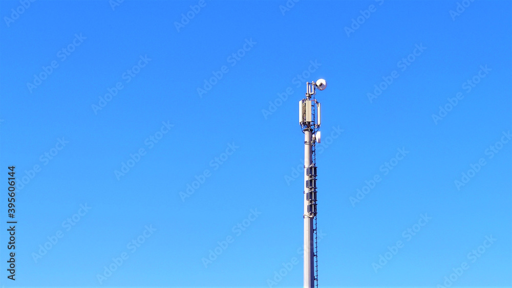 Telecommunication tower with antennas against blue sky background with copy space. Telecommunication tower with antennas against blue sky background with copy space.