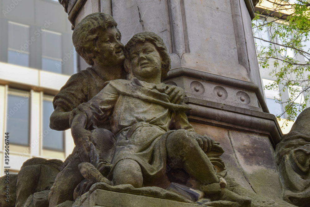 Fragment of an old monument with sculptures of children