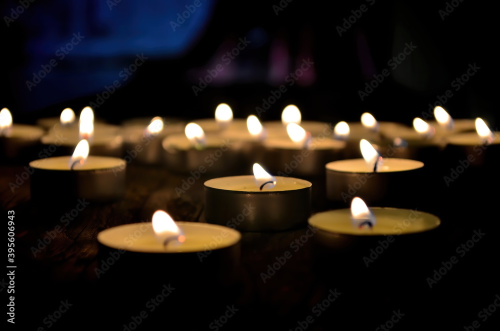 Many small christmas candles burning at dark. Shallow depth of field, selective focus Many small christmas candles burning at dark. Shallow depth of field, selective focus