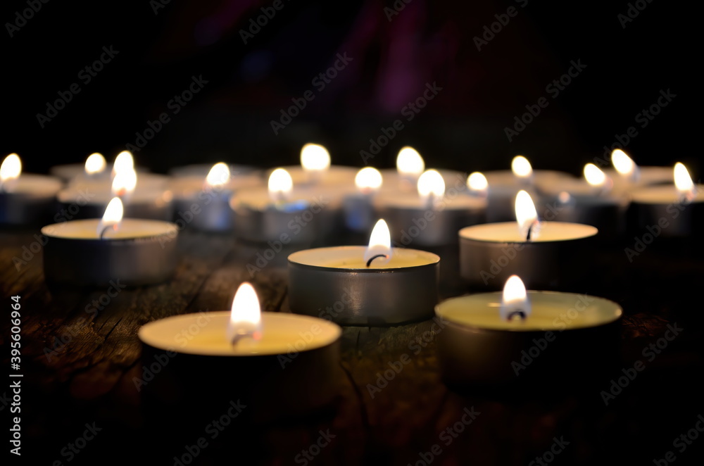 Many small christmas candles burning at dark. Shallow depth of field, selective focus Many small christmas candles burning at dark. Shallow depth of field, selective focus