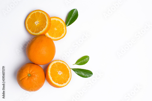 Whole and sliced orange fruit on white background
