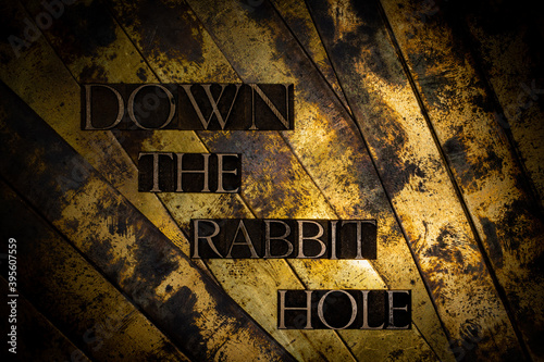 Down The Rabbit Hole text message on textured lead grunge copper and vintage gold background
