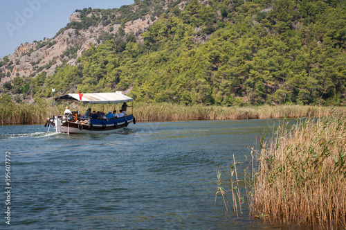 Turkey. Boat trip on the Dalyan river with mountains in the background.