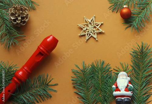 christmas background with a little santa claus, a recorder and fir branches