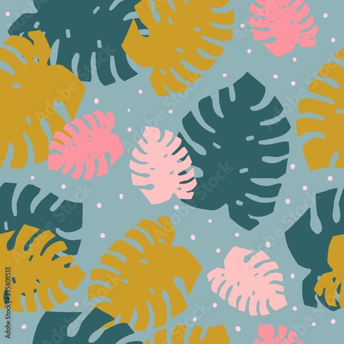 A simple pattern of monstera. Blue background  pink  mustard and dark blue monstera leaves  dots. The print is well suited for textiles  Wallpaper and packaging.