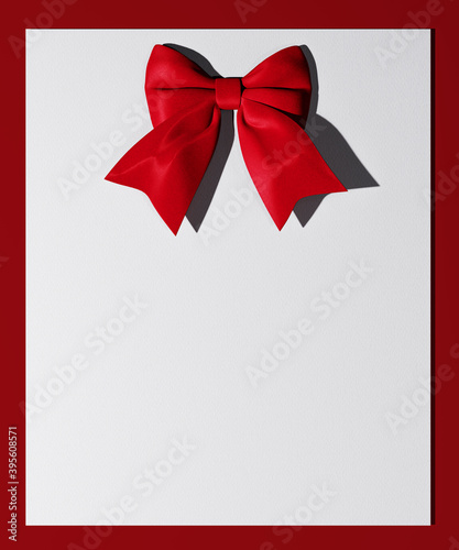 Red bow on paper, holidays card