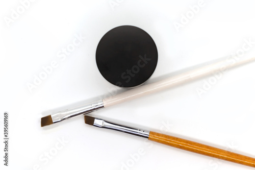 Brushes and shadows for professional correction and coloring of eyebrows on a white background. Top view.
