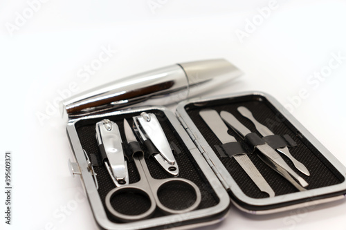 Tools of a manicure set and mascara isolated on white background