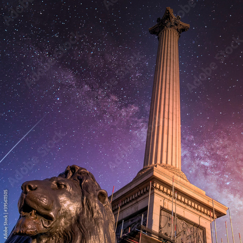 London, UK, Trafalgar square, Nelson's column and lions statue under starry night sky photo