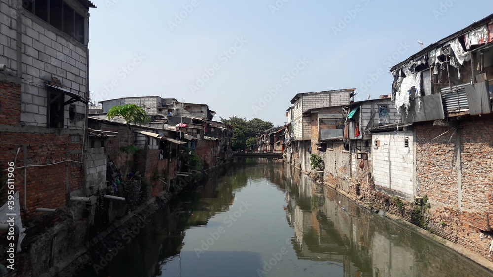 Slum area located on the banks of a dirty river