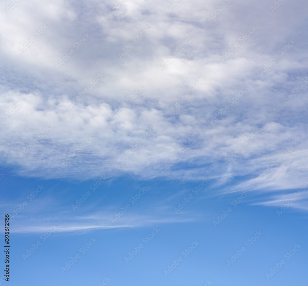 Sky background, lower part is clear blue, upper with cirrus clouds