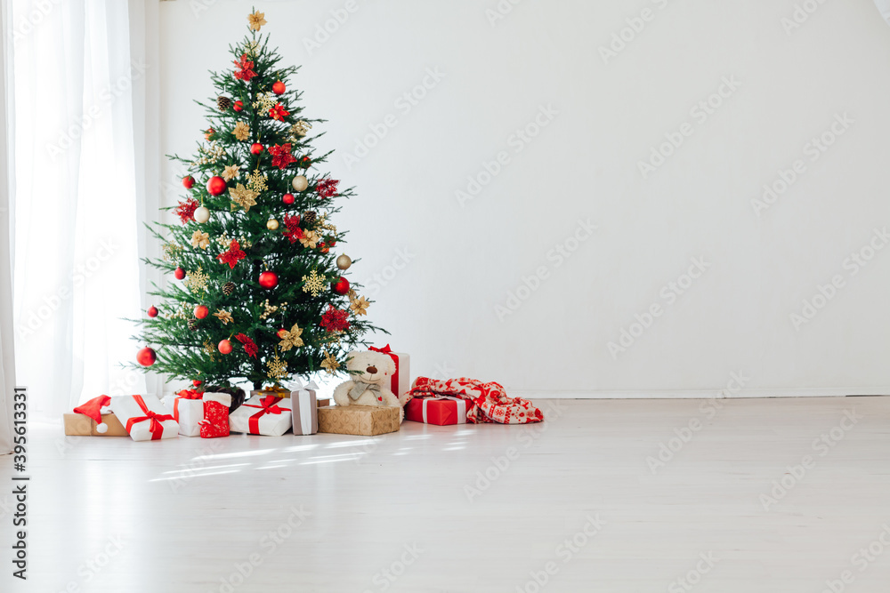 Big beautiful christmas tree decorated with beautiful shiny baubles and many different presents on wooden floor. Big beautiful christmas tree decorated with beautiful shiny baubles and many different presents on wooden floor.