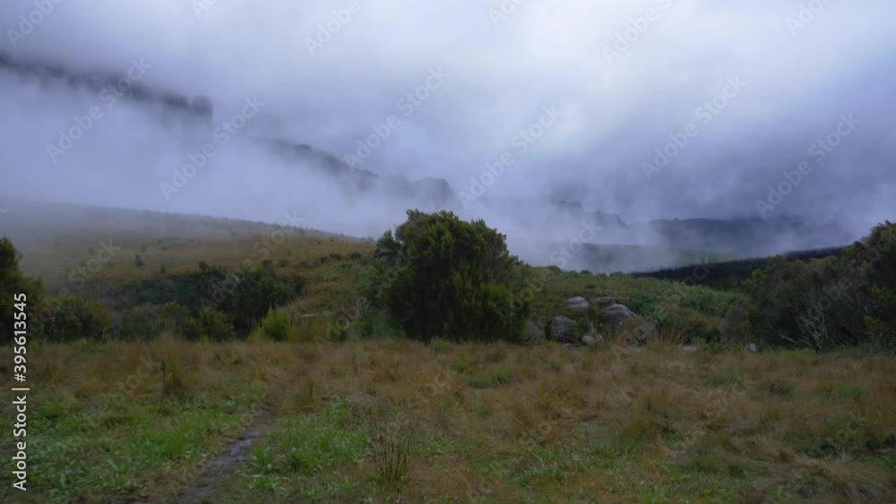Evening mist rolling in slow wind over evening landscape at Pic Boby base camp, typical scenery of Andringitra national park, Madagascar Evening mist rolling in slow wind over evening landscape at Pic Boby base camp, typical scenery of Andringitra national park, Madagascar