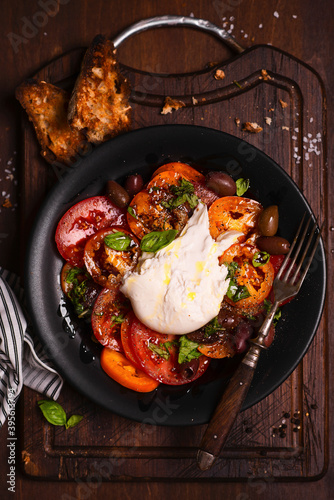 Red and yellow tomato salad with burrata, basil and balsamic vinegar