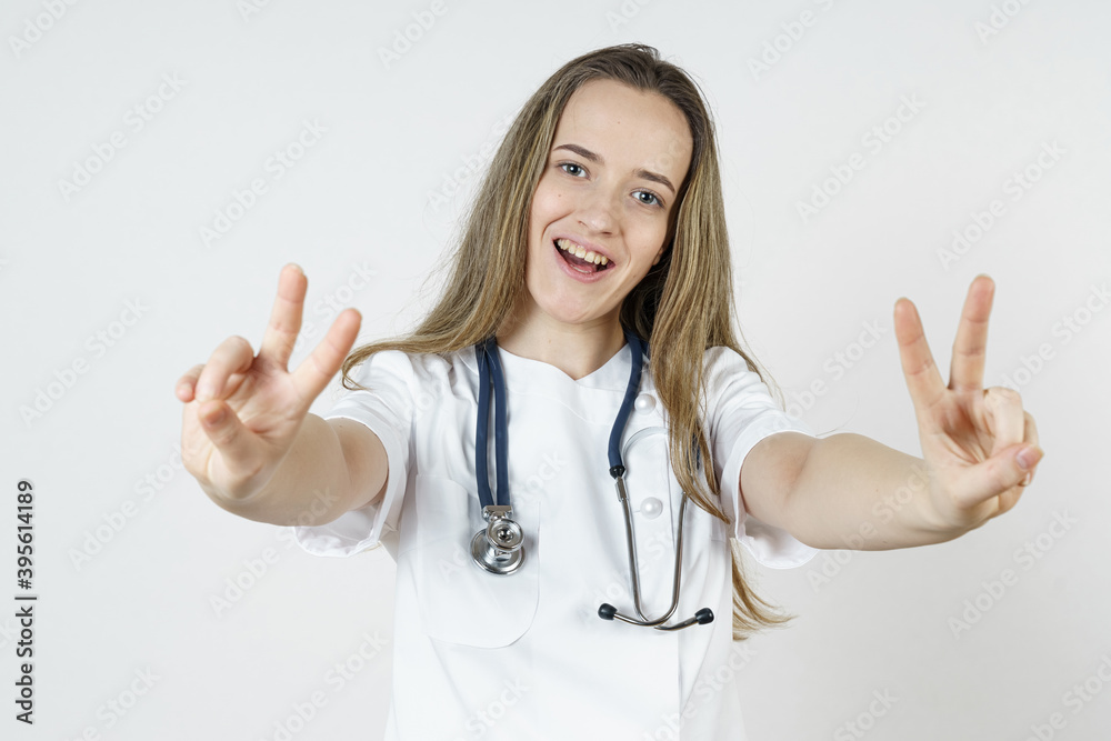 Medicine and health concept. A woman doctor shows a hand gesture indicating that everything is fine. Medicine and health concept. A woman doctor shows a hand gesture indicating that everything is fine.