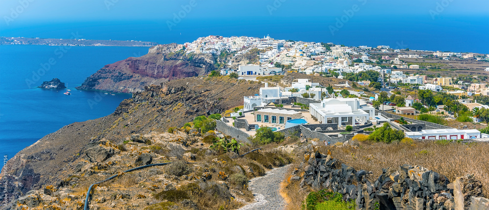 A view down the Caldera rim path towards the town of Oia in Santorini in summertime