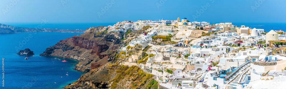 A panorama view of the town of Oia on the edge of the Caldera in Santorini in summertime