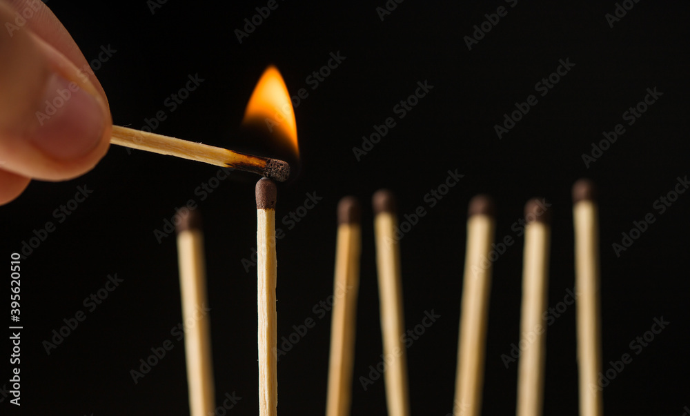 wooden lighted matches, standing on a black background wooden lighted matches, standing on a black background