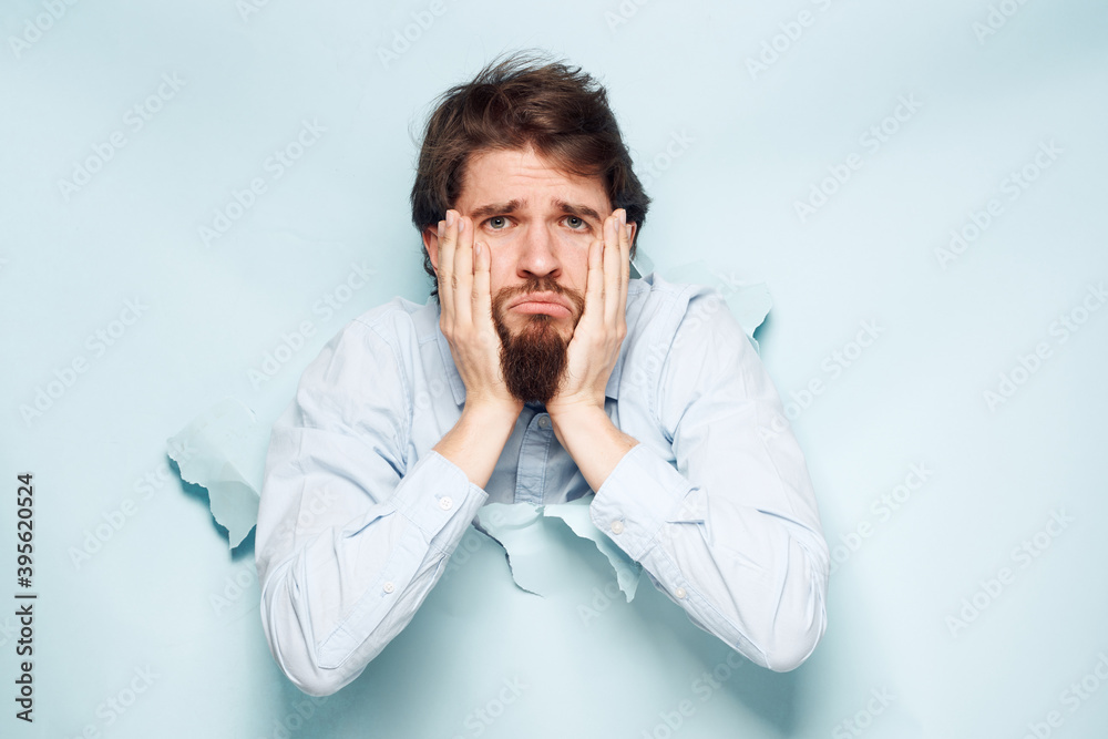 A man in a shirt peeks out from behind the wall of a career work emotions A man in a shirt peeks out from behind the wall of a career work emotions