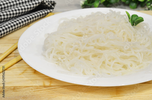 Konjac or Shirataki noodles with Chinese chopsticks. Japanese traditional dish. Healthy food for weight loss, keto diet concept