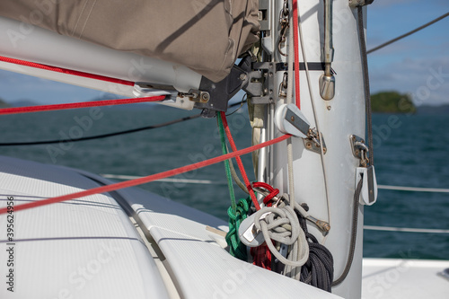 View of the blue sea water from the side of a sailboat with rigging and sails. Tackle barge, sail, masts, yards, deck, ropes,