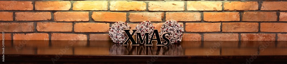 Obraz premium Xmas inscription and Christmas decorations on the background of an old brick wall.