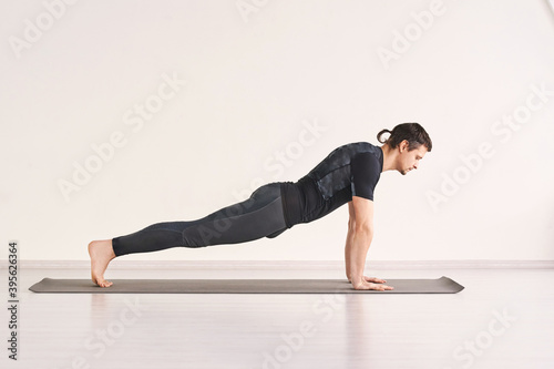 Man stand at plank. Home sport static training. Social distancing quarantine lifestyle. Health pushup. Person yoga asana. Ashtanga pose. Muscle stretching. Morning fitness effort