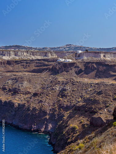 A view of the rocky cliffs along the Caldera rim from Akortiri in Santorini in summertime photo