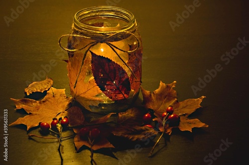 Candleholder surrounded by foliage