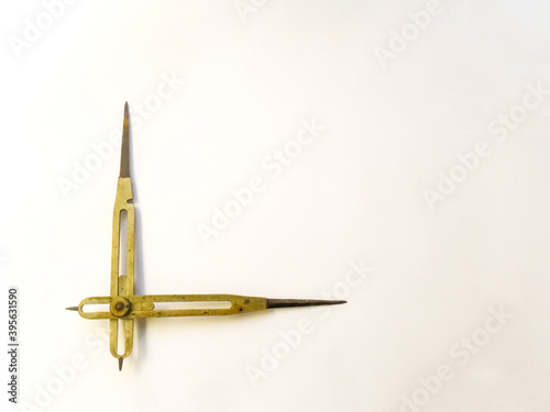 Old brass reduction compass or proportional scale divider. Geometry tool used to scale designs.
