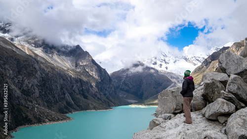 Hiker arrives at viewpoint at Paron Lake with Piramide peak in the background