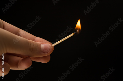 wooden lighted matches, standing on a black background