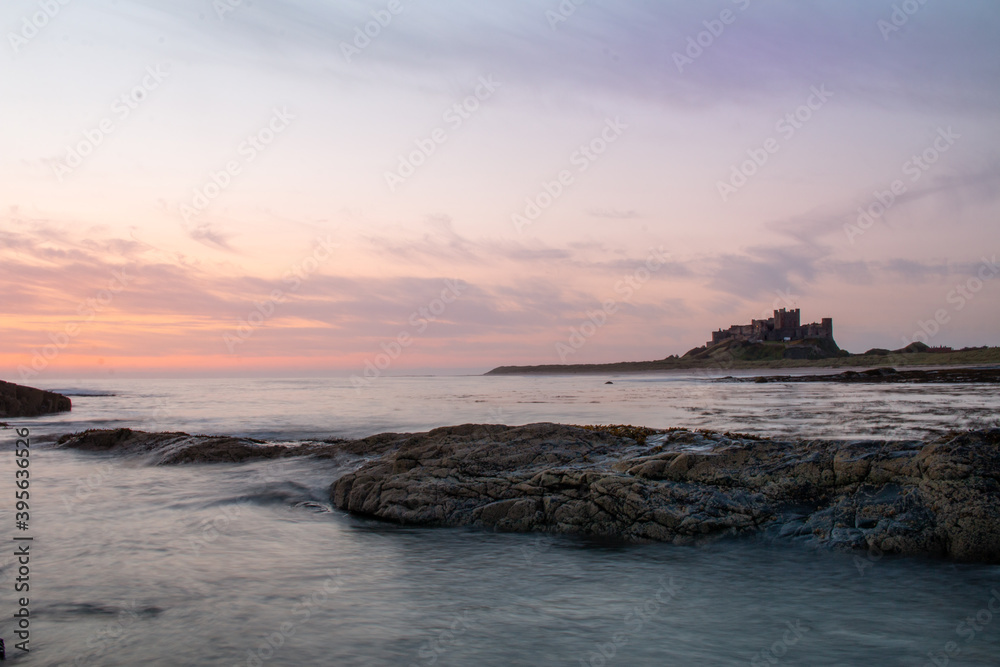 Obraz premium Sunrise on medieval castle at beach